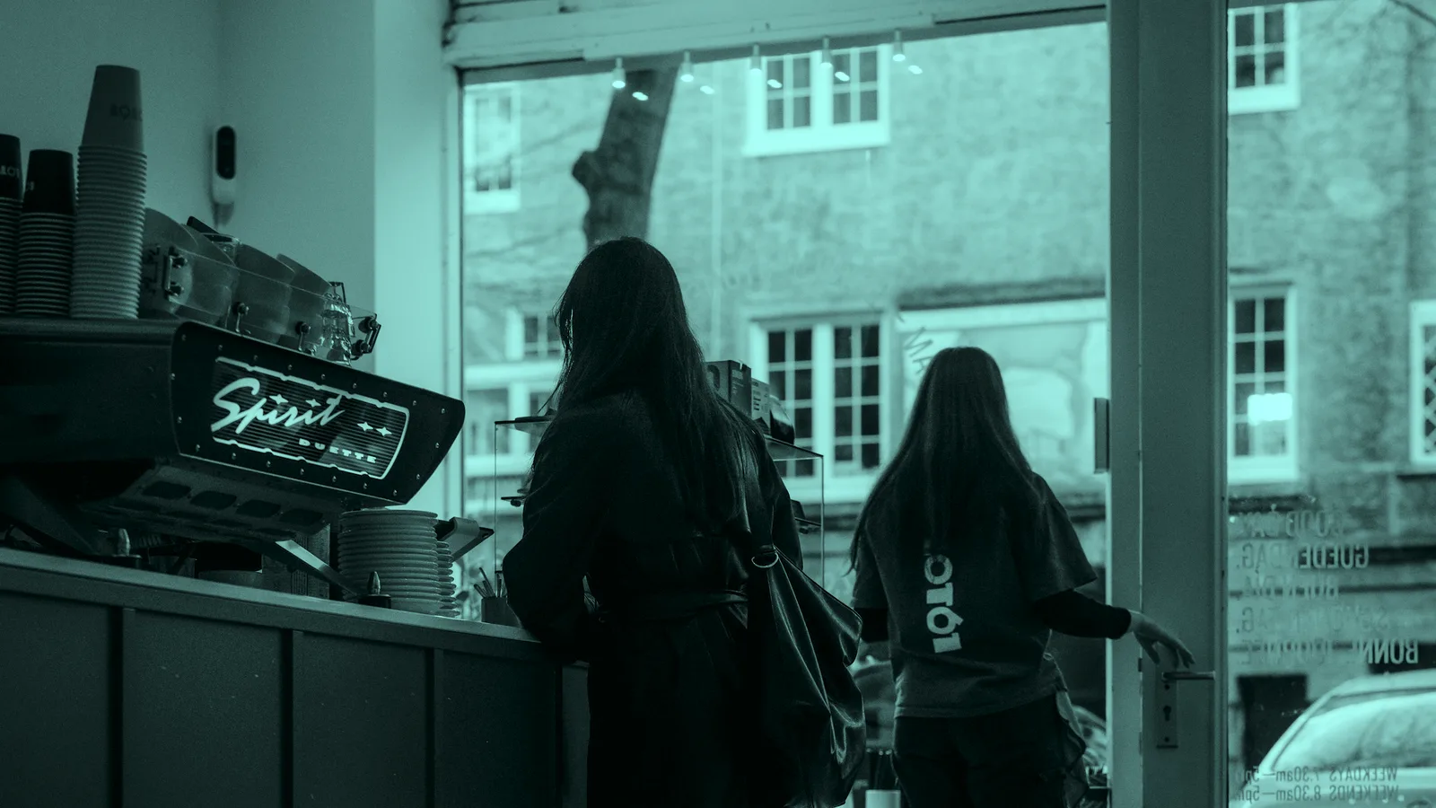 Customers at a cafe counter in morning light, tinted teal